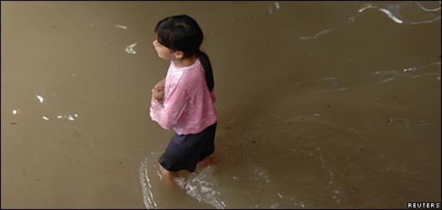 Una niña camina en su casa inundada en Guatemala