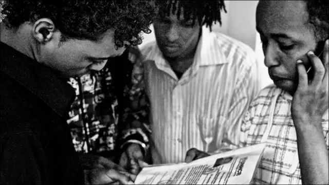 Несколько человек склонились над документом с пометкой UNHCR