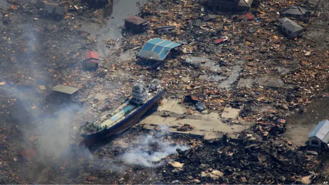 A ship washed away by tsunami sits amid debris in Kesennuma, Miyagi Prefecture, Sunday, March 13, 2011 after Japan"s biggest recorded earthquake hit its eastern coast Friday