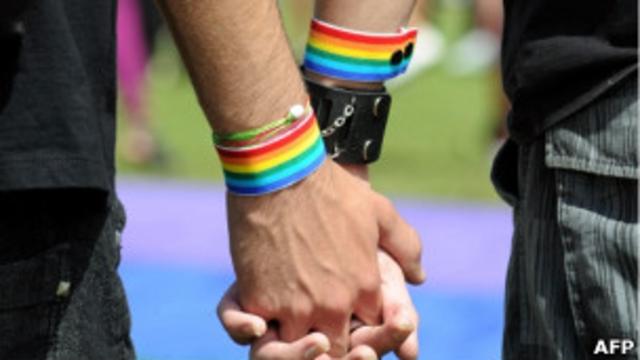 Casal gay se dá as mãos durante manifestação em Brasília. Foto: AFP