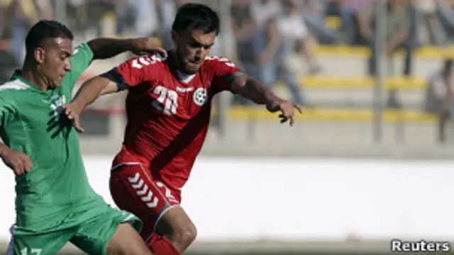 Jugador de Afganistán disputa el balón con un jugador palestino