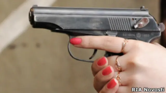 Женщина стреляет из пистолета