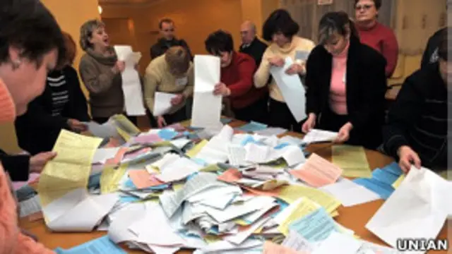 члени виборчої комісії рахують бюлетені 