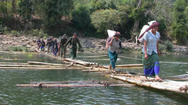 Dân và bộ đội Karen hành quân qua suối