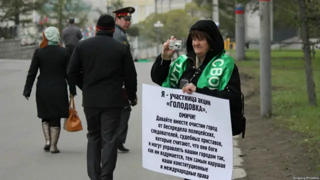 Женщина с политическим плакатом 