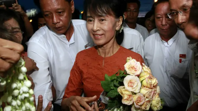 Bà Suu Kyi nhâṇ hoa của người hâm mộ tại sân bay Rangoon
