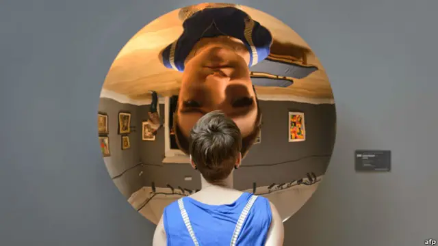 Một phụ nữ đứng trước một tác phẩm của Anish Kapoor