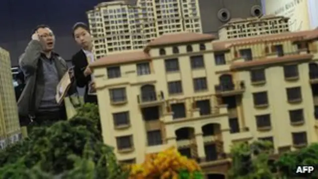 北京某中外房地產展銷會上凖買家審視樓盤模型(5/4/2012)