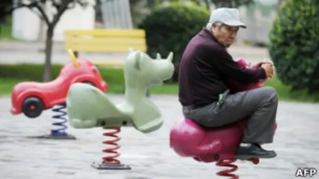 Пожилой китаец на детской площадке