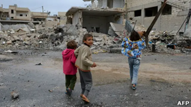 Сирийские дети на фоне руин