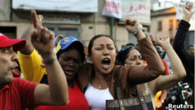 Сторонники покойного президента Венесуэлы Уго Чавеса возле госпиталя в Каракасе, где он скончался (5 марта 2013 года)