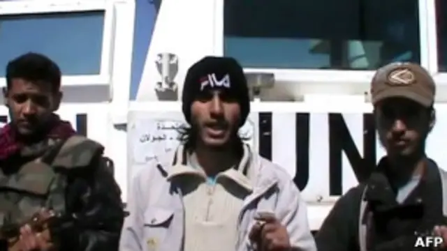 Сирийские боевики на фоне автомашины ООН