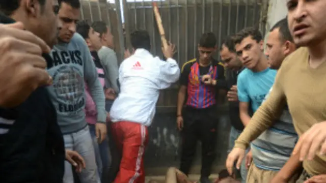 سكان قرية محلة زياد وهم يضربون الرجلين