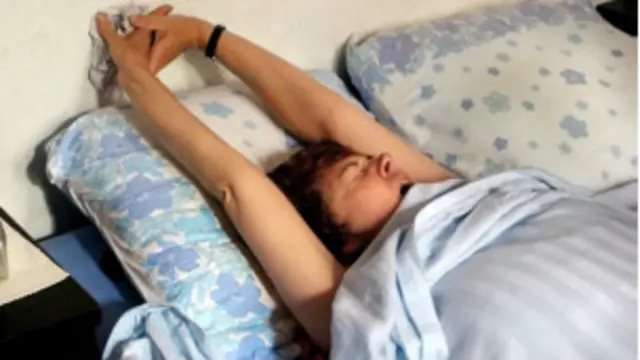 Niño estirándose en la cama