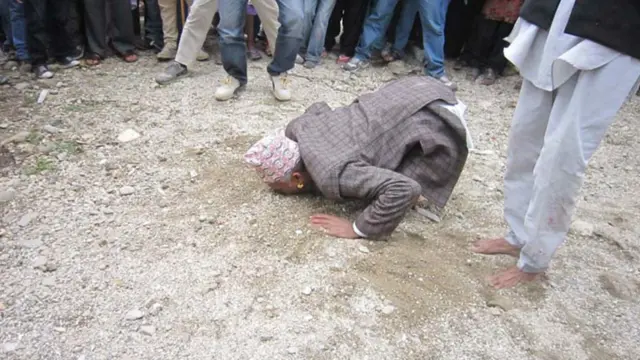 Dukun sedang memakan pasir