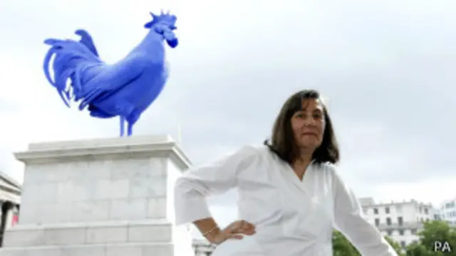 Скульптор Катарина Фритш на фоне синего петуха