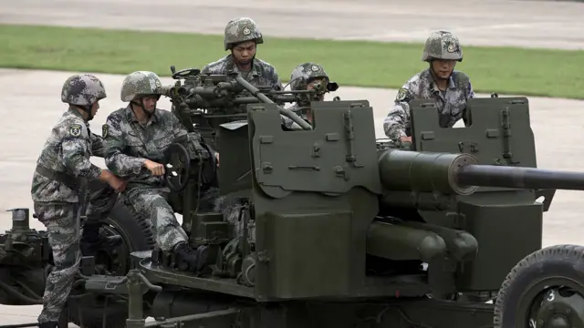 士兵们示范操作PG59型57毫米防空炮。