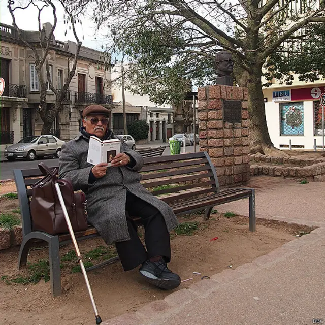 Un señor sentado cerca del monumento a Salvador Allende en Uruguay
