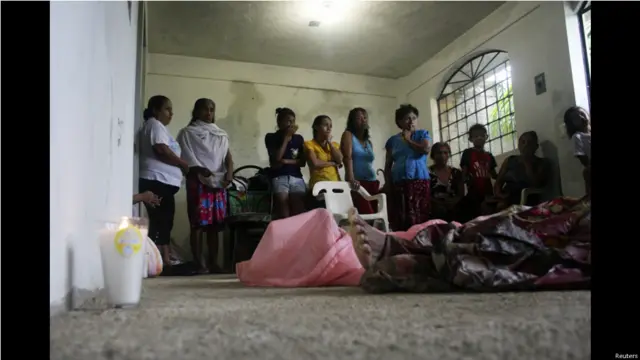 Los miembros de una comunidad de Acapulco velan a algunos de los 21 muertos que han ocasionado la tormenta y el huracán en Mexico.