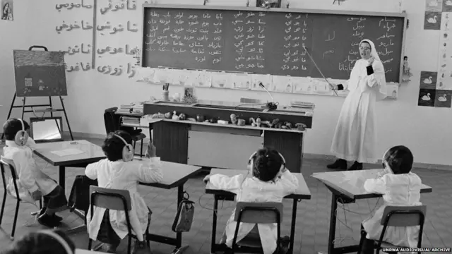 انشأت وكالة الأونروا حوالي 700 مدرسة للاجئين الفلسطينيين، مما يوفر فرصة تعليم لحوالي نصف مليون طفل. الصورة لراهبة تدرس مجموعة من الأطفال في مخيم البقعة عام 1970.