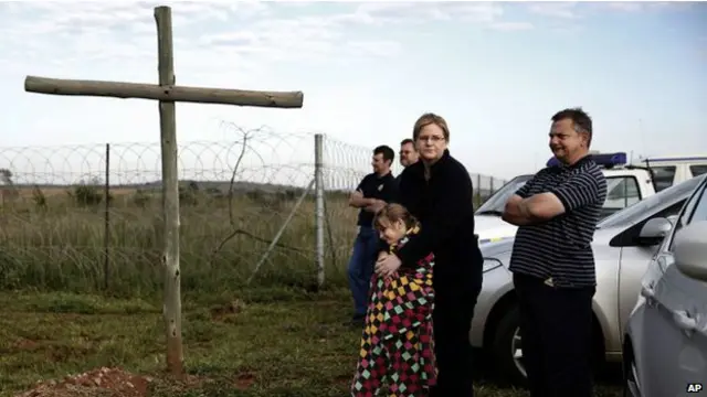 नेल्सन मंडेला के ताबूत की अंतिम झलक पाने के लिए वाटरक्लूफ हवाई पट्टी के बाहर इंतजार करते उनके प्रशंसक.