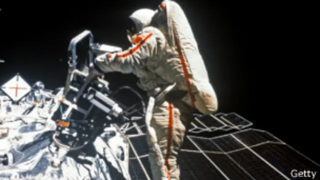 an astronaut repairing a malfunction in the Space