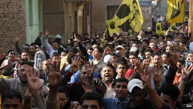 Muslim Brotherhood supporters march on the first day of the referendum, in Giza