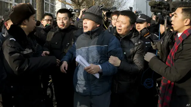 张庆方在北京市第一中级法院外于民警押送下接受境外记者采访（26/1/2013）