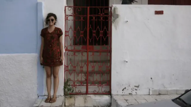 Lily em frente à sua casa no Recife 