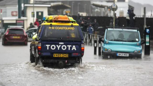 海岸救援車在洪水中艱難行駛。