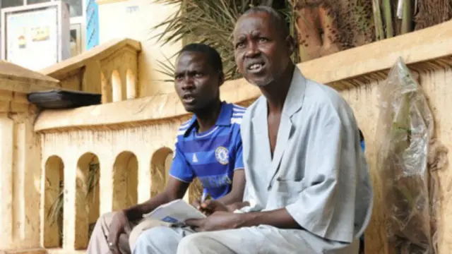 Alassane Maiga (right) and a customer