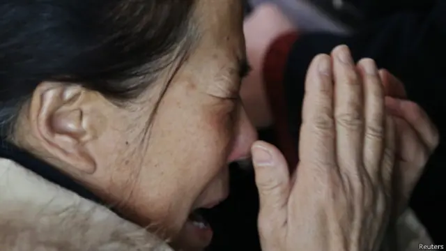 Seorang warga Cina menangis menanti kabar nasib keluarganya yang menjadi pesawat Malaysia Airlines.