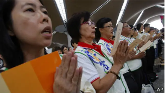 Familiaresf10 betpassageiros do voo da Malaysia Airlines rezam | Crédito: AP