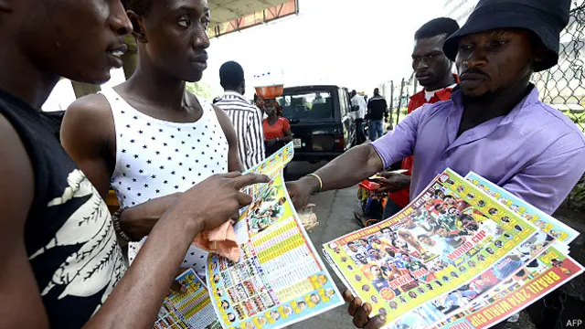 लागोस में फ़ुटबॉल विश्व कप का कार्यक्रम बेचता एक व्यक्ति