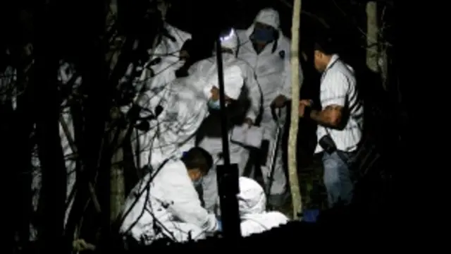 Peritos forenses trabajan en una fosa clandestina. Foto Getty Images.