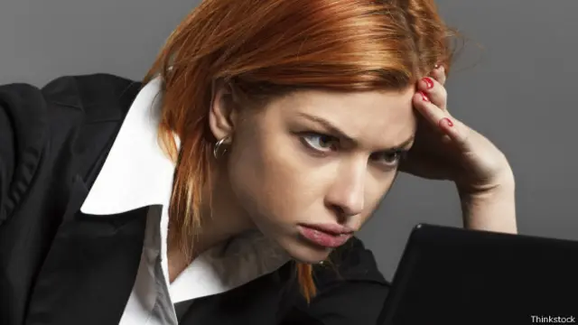 Женщина напряженно всматривается в монитор