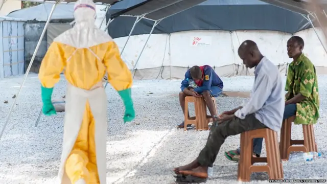 Virusi hivyo huenea kwa haraka sana, na hadi sasa hakuna dawa inayotambulika kuweza kuvitibu, kwa hivyo wanaotoa huduma za matibabu huvalia mavazi yanayowakinga kutokana na kuambukizwa kwa ugonjwa huo. Kulingana na uzito wa athari za ugonjwa huo, hadi kufikia asilimia 90 ya walioambukizwa huaga dunia. Anayehakikisha usafi anawakaribia wagonjwa wanaosubiri matokeo baada ya kupimwa damu.