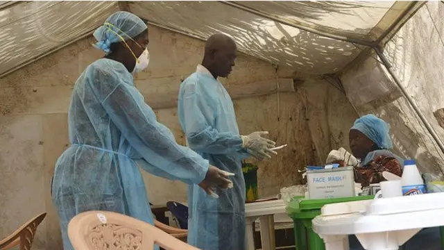 عمال الصحة في سيراليون يأخذون عينات دم من سيدة لتحليلها للتأكد من احتمال إصابتها بالفيروس.