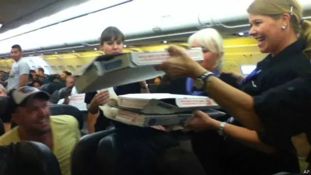 Piloto pede pizza para distribuir entre passageiros após atraso em voo | Crédito: AP