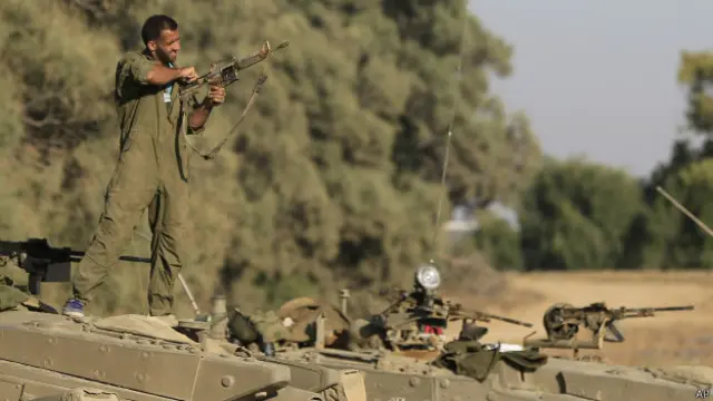 Soldado israelense chega sua arma proximo a faixa de Gaza. Ataques começaram na terça-feira