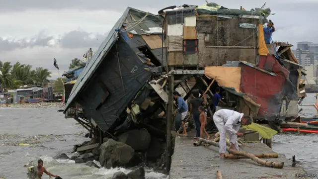 菲律賓馬尼拉巴塞科貧民窟居民清理被颱風吹塌的棚屋(17/7/2014)