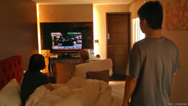 王先生一家三代五口落脚商旅，只是应急之策（BBC中文网照片，02/08/2014）