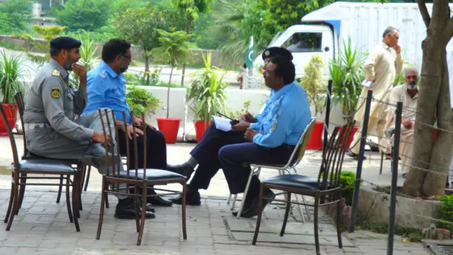 پولیس کے اہلکار انتظار میں ہیں کہ ڈبوں میں پیک کھانا گاڑیوں میں لوڈ ہوجائِے تو اسے چیک پوائنٹس پہ پہنچادیا جائے