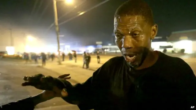 متظاهر يسكب الحليب على وجهه لحمايته من الغاز المسيل للدموع