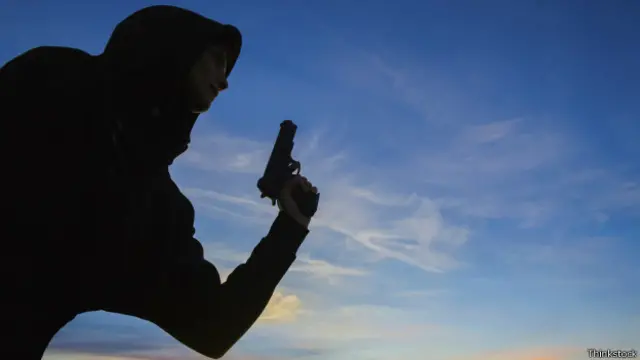 Mulher segura uma pistola (foto: Thinkstock)