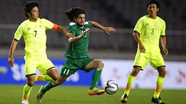 لاعب المنتخب العراقي همام طارق يحاول الابتعاد بالكرة