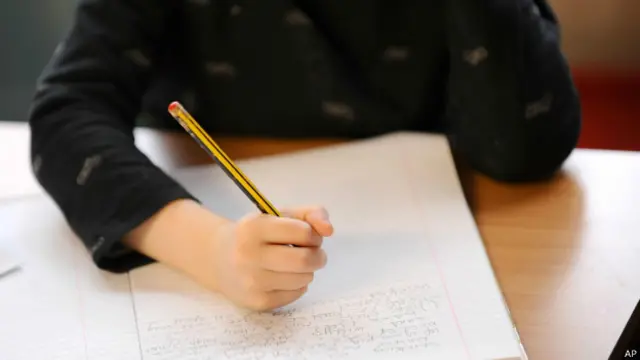 Criança escrevendo na escola / Crédito: AP