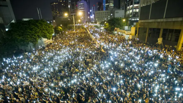Manifestantes alzan sus teléfonos celulares durante una protesta en Hong Kong el 29-09-2014. 