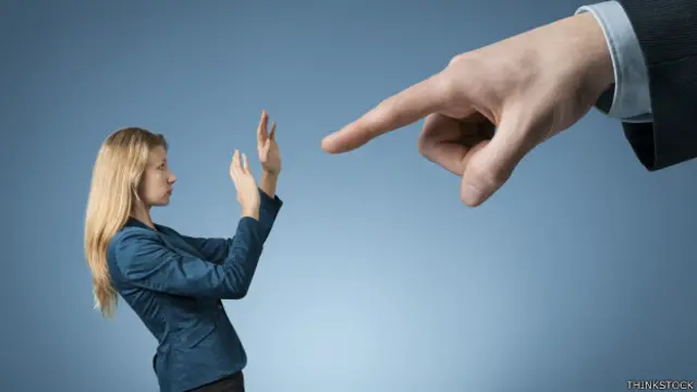 Jefe apunta con el dedo a una mujer a quien despide