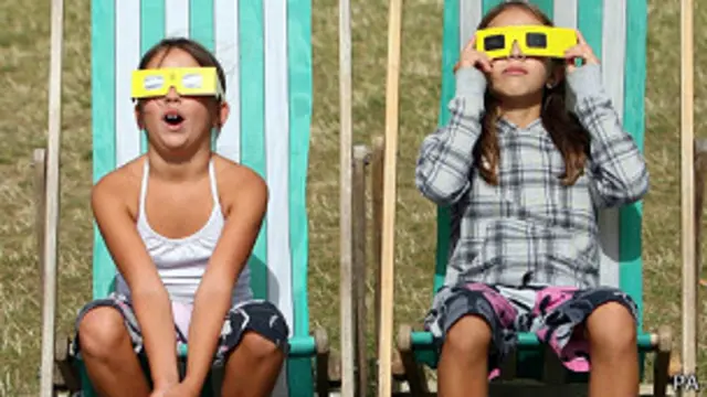 Niñas mirando un eclipse